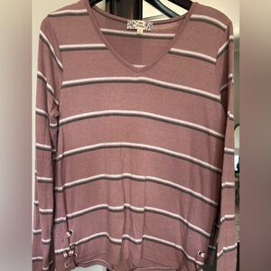 Adorable soft long sleeve top with side details.